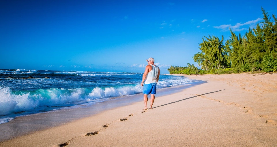 Fotograf René Cerny – Reisefotografie. René geht bei Sonnenschein am Strand entlang, Hawaii.